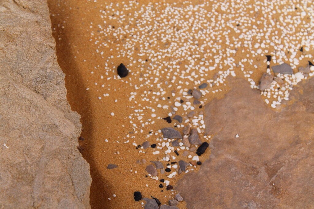 Close up of sand granules and heavy black rocks found in Agabat Valley.