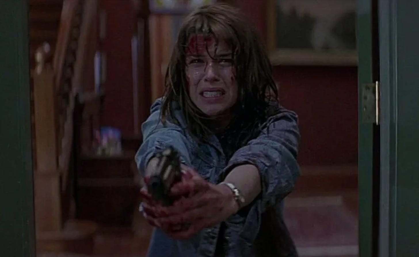 Sidney Prescott in Scream holding up a gun to Stu and Randy.
