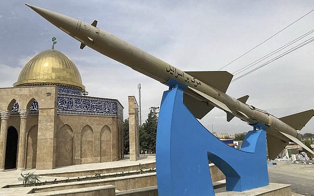 A missile is on display with a sign reading 'Death to Israel' in Persian, in front of a mosque in the shape of Dome of the Rock at the entrance of the Quds town west of the capital Tehran, Iran, Sunday, April 21, 2024. (AP Photo/Vahid Salemi)