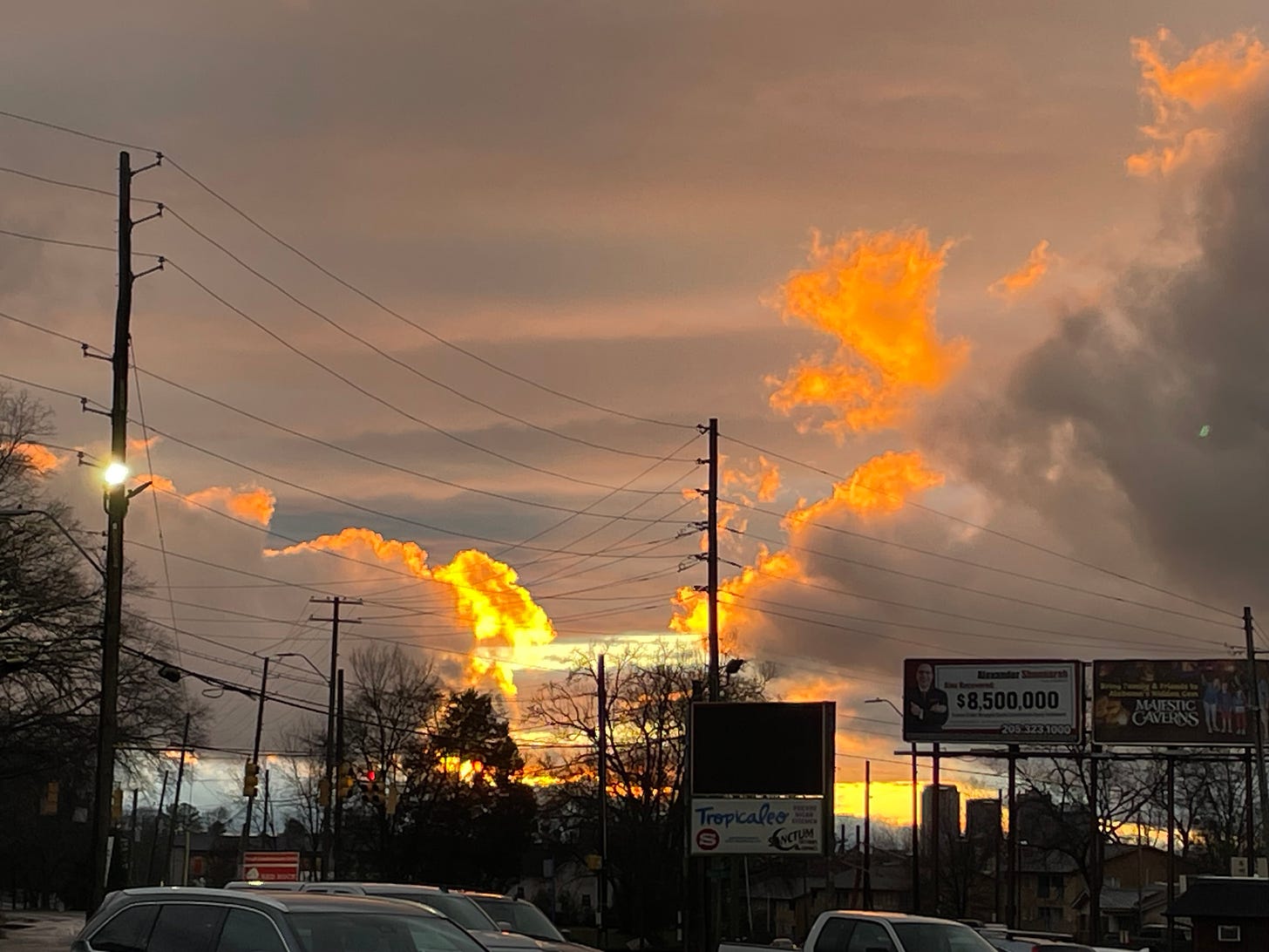 A cloudy sunset along a busy city road in Birmingham