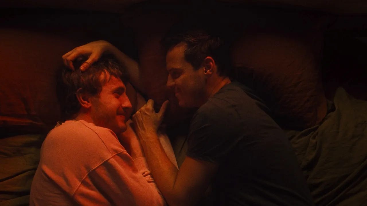 An image from the film All of Us Strangers, showing Paul Mescal and Andrew Scott lying on a bed facing each other.