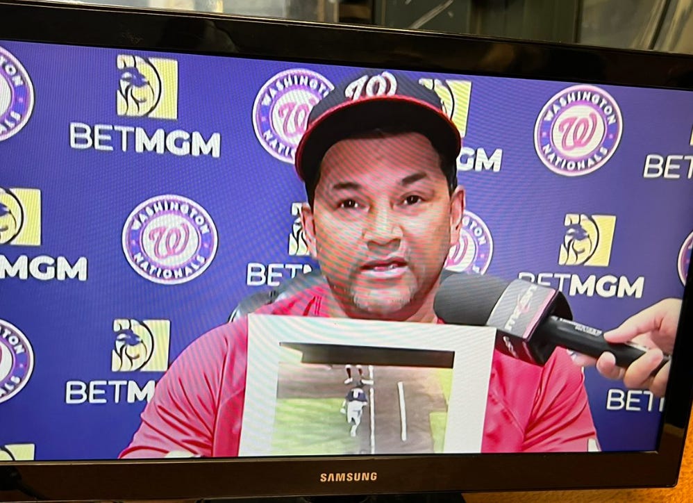 Dave Martinez on TV showing the still photo