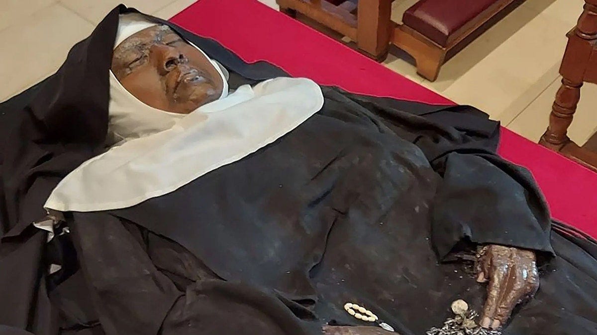 A deceased African American religious sister dressed in a Catholic habit. 