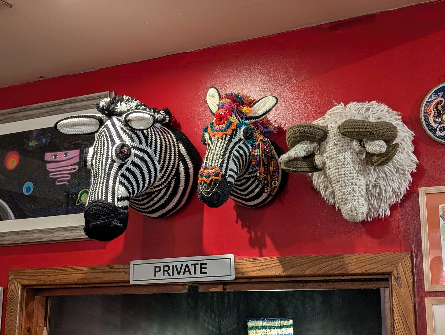 Knitted zebra and sheep's heads