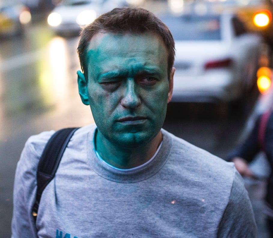 A person with green face paint

Description automatically generated