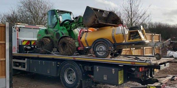 Farm machinery on the back of a truck
