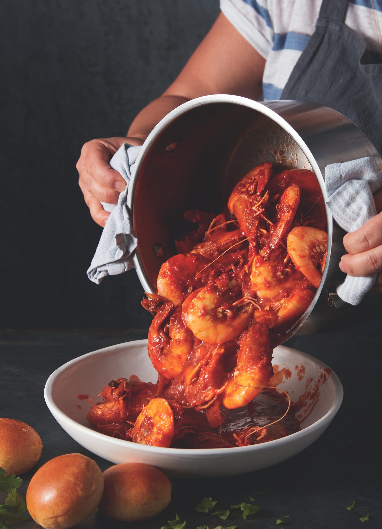 pot of singapore chili shrimp being dumped onto a plate
