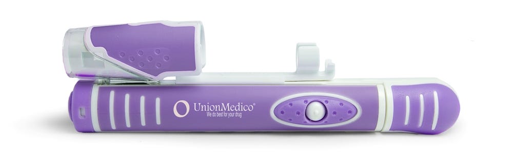 An image of an autoinjector. It is plastic, in white and violet, and a button is showing toward the viewer.