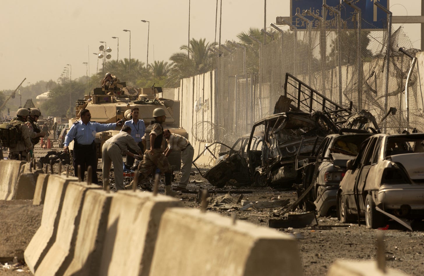 At 9:10 this morning outside gate three of the green zone, Iraqi police supported by U.S. forces, respond to a vehicle born improvised explosive device explosion, July 14, 2004. 