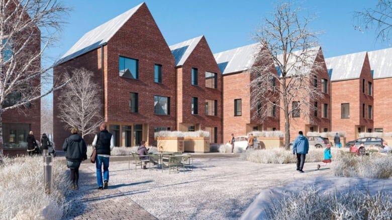 A rendering of low-rise brick buildings around a courtyard in winter.