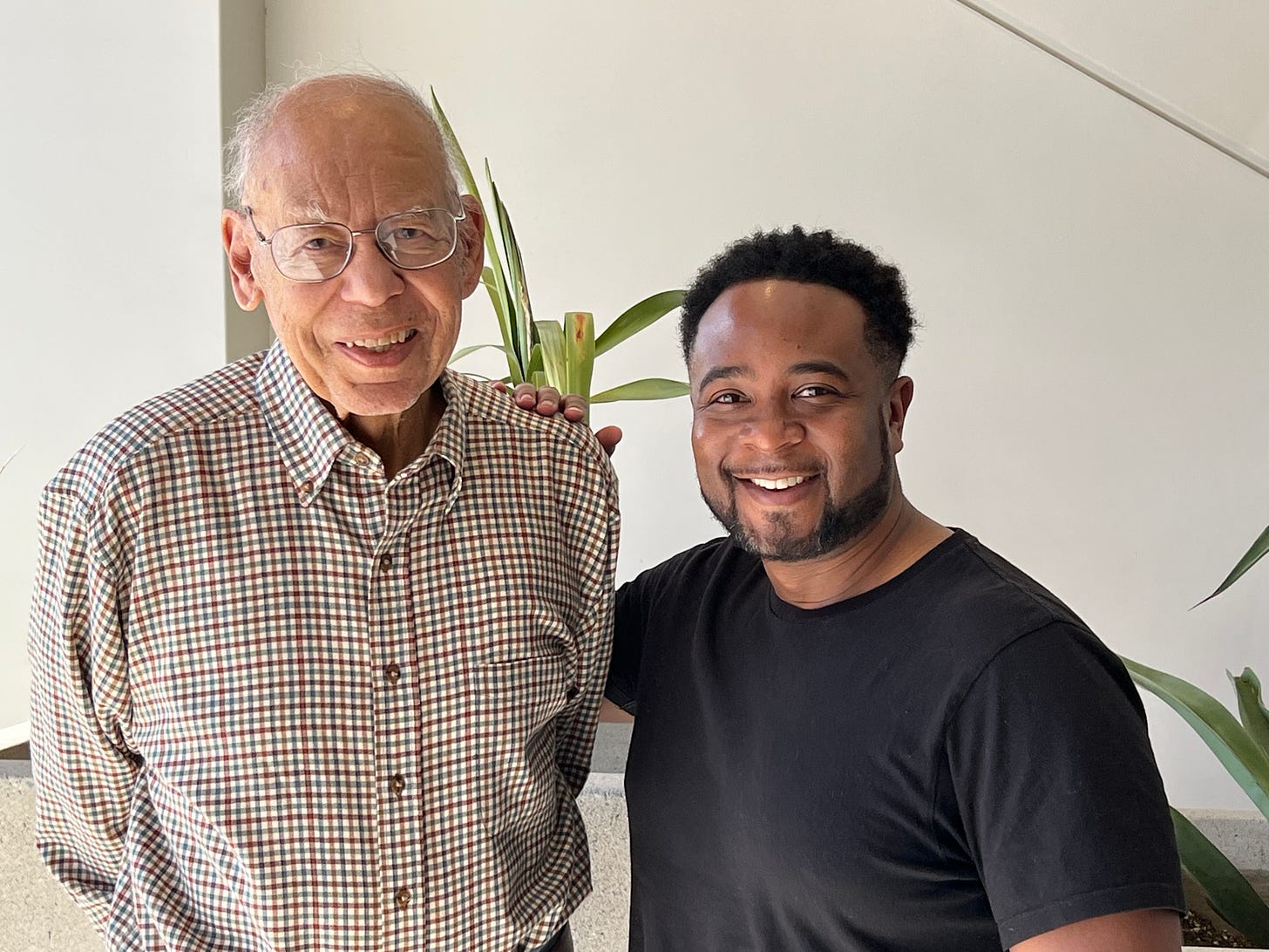 Photo of Dr. Bill Pannell in a button-down shirt smiling next to Jemar Tisby in a Black t-shirt 