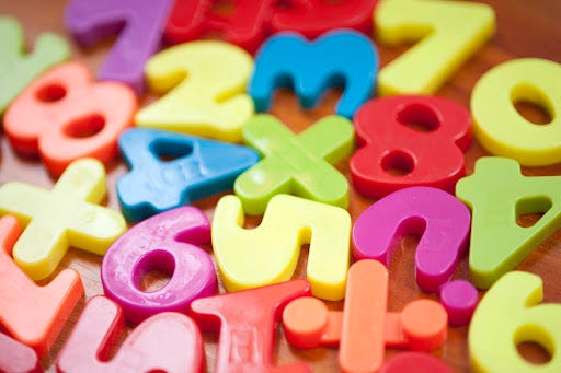 a photo of disorganized children's magnetic numbers toy
