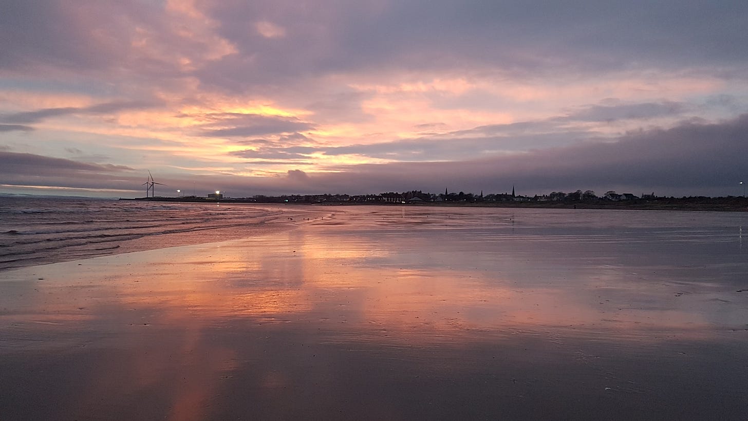 Beautiful purple and pink sunset on huge Leven Beach