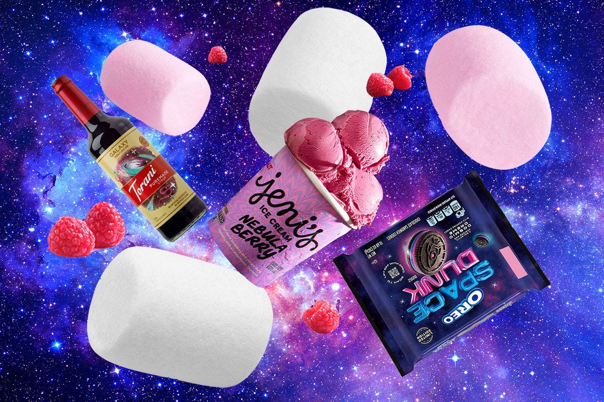 A collage against a galaxy backdrop, with floating marshmallows and raspberries, Torani galaxy-flavored syrup, Jeni’s Nebula Berry ice cream pint, and a package of Oreo’s Space Dunk cookies
