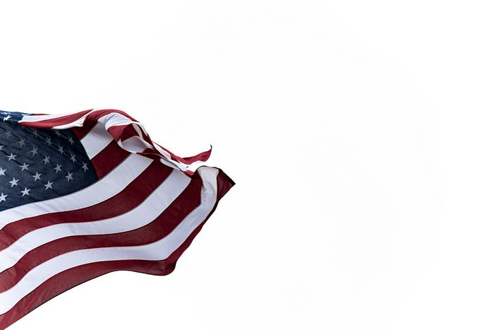 A waving American flag against a white background. A waving American flag against a white background.