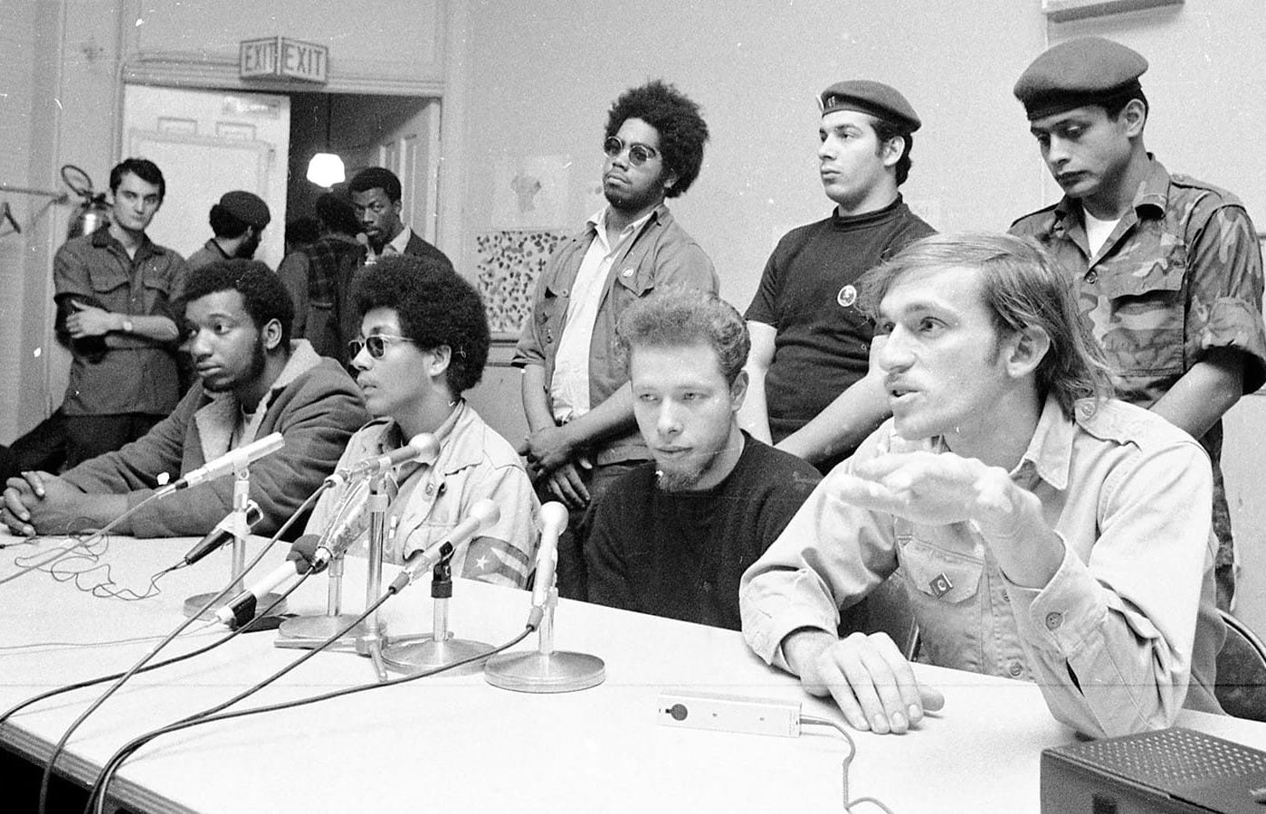 Fred Hamptonand José “Cha Cha” Jiménez sit at a table