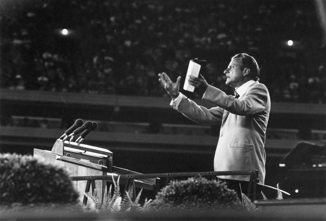 Evangelist Billy Graham addressing a large gathering in 1955.