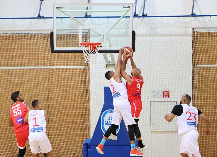 Picture of UAE basketball player blocking egyptian national team member in a friendly match