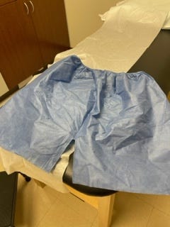 Terribly unflattering disposable blue shorts you get to wear in an ortho appointment.