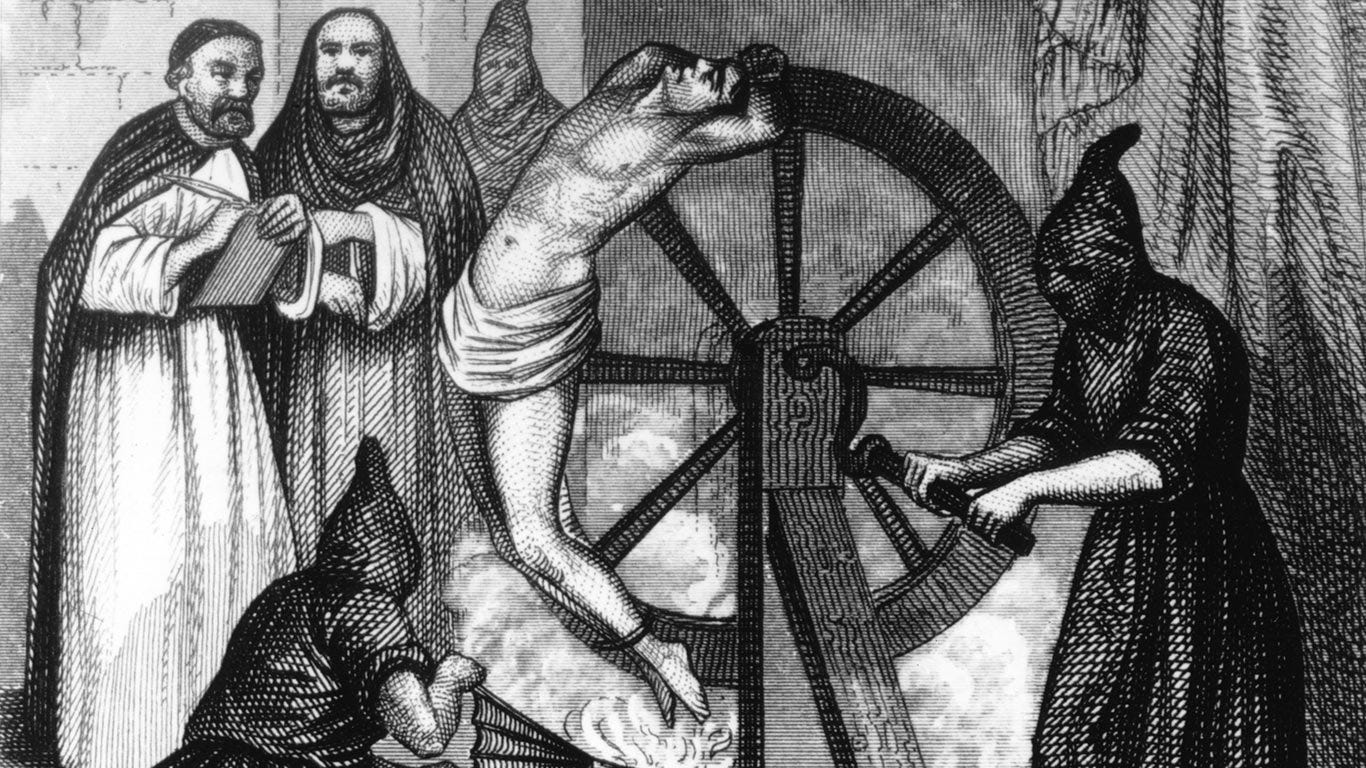 Black and white image of a man being tortured during the Spanish Inquisition