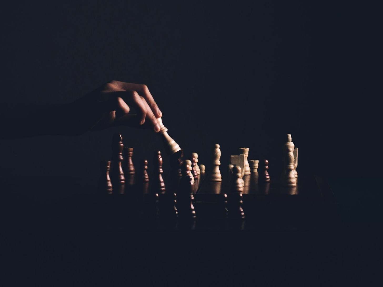 person playing chess board game