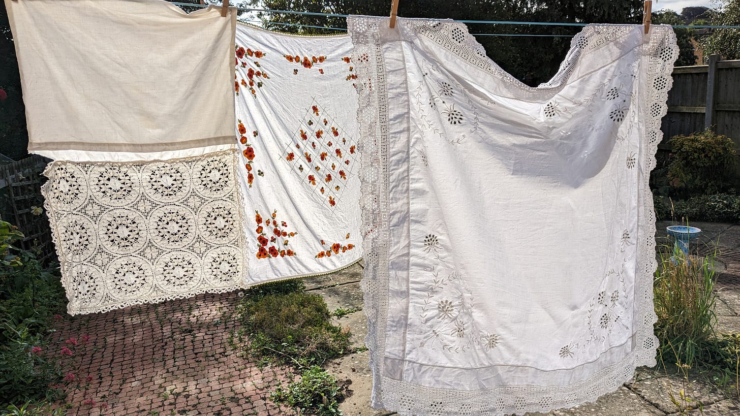 Antique lace tablecloths hanging on a washing line