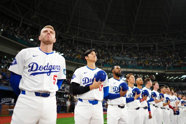 Freddie Freeman and Shohei Ohtani of the Los Angeles Dodgers stand during the national anthem prior to the 2024 Seoul Series game between the Team...