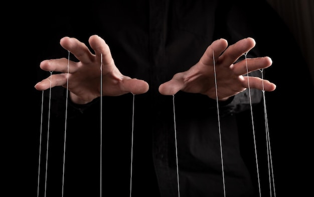 Premium Photo | Man hands with strings on fingers manipulation negative  influence or addiction concept becoming dependent on alcohol drugs gambling