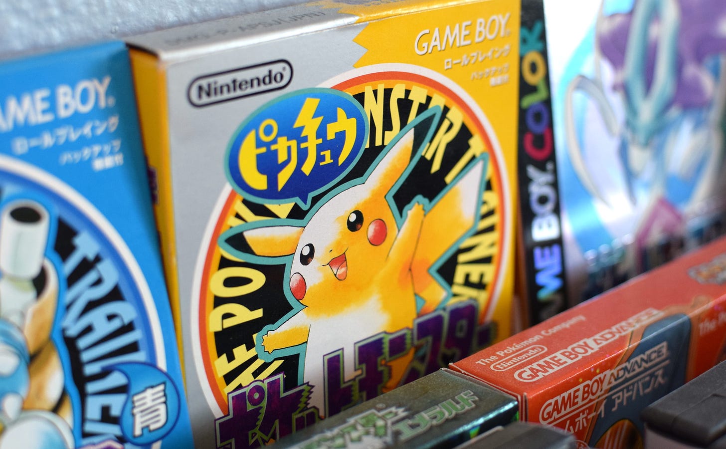 A photograph showing Chris’s collection of Japanese Pokémon games, which include Pokémon Blue, Yellow, Crystal, Emerald, and FireRed