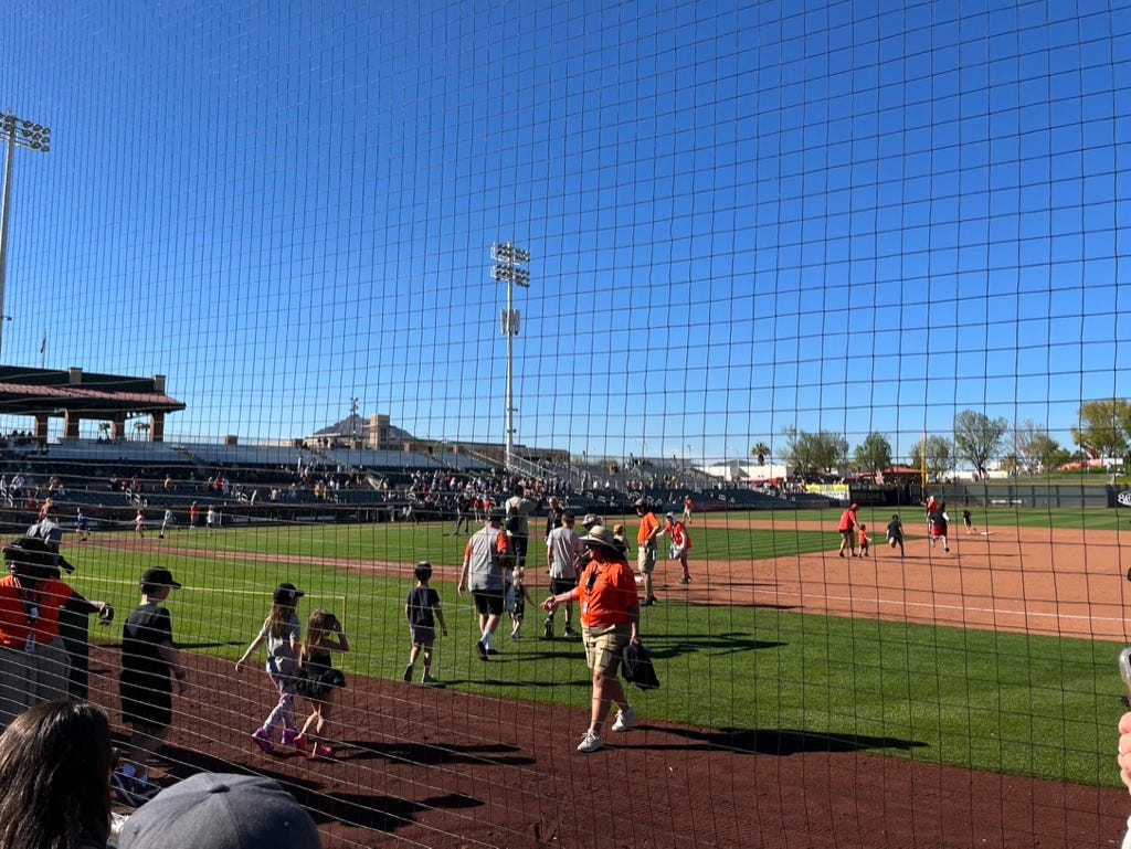 Children going onto the field at Scottsdale Stadium to run around the bases after a game.