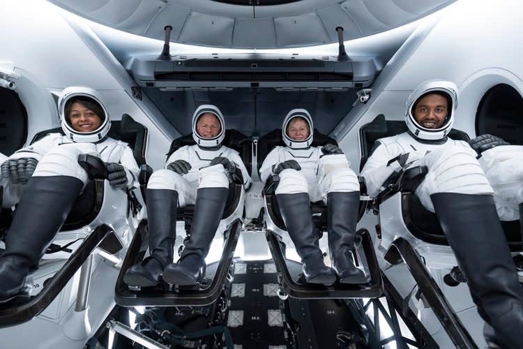 A group photo of the Axiom Mission 2 crew aboard a SpaceX Crew Dragon. From left to right, the astronauts are Rayyanah Barnawi, John Shoffner, Peggy Whitson and Ali Alqarni.
