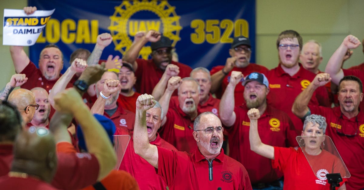 President Fain and the Daimler bargaining team dressed in red and raising fists in solidarity at the Daimler rally in North Carolina on April 2, 2024.