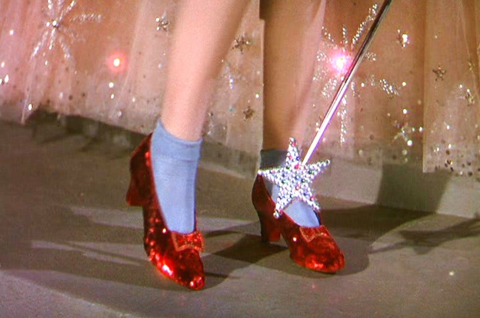 Judy Garland wearing the ruby slippers in The Wizard of Oz.