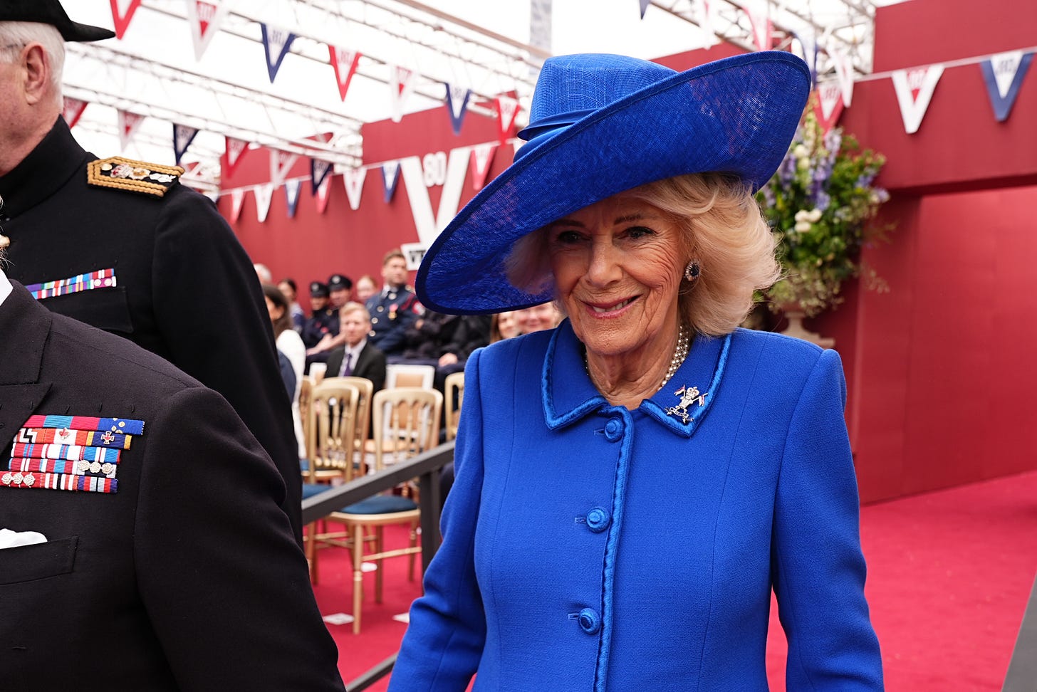 Queen Camilla wearing blue outfit and Lancers brooch