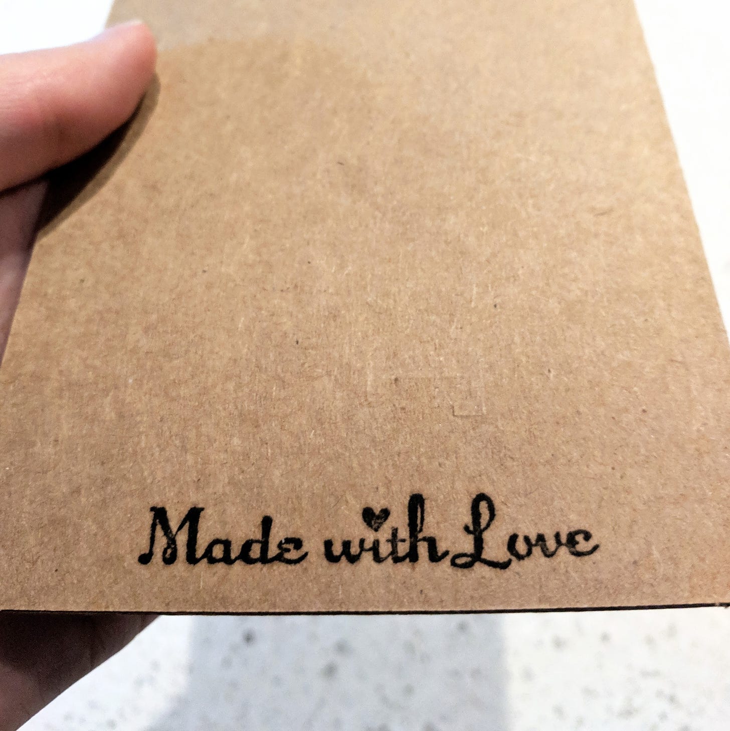 back of a handmade card featuring "made with love" stamp