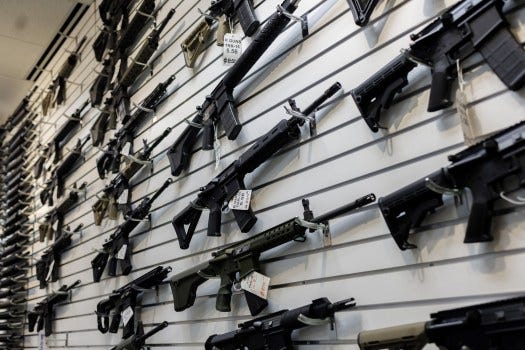 A selection of AR-15-style rifles hangs on a wall at R-Guns store on Jan. 11, 2023, in Carpentersville, Illinois, a day after the state banned them. On Tuesday, Washington became the 10th state to ban the rifles. (Armando L. Sanchez/Chicago Tribune/TNS)