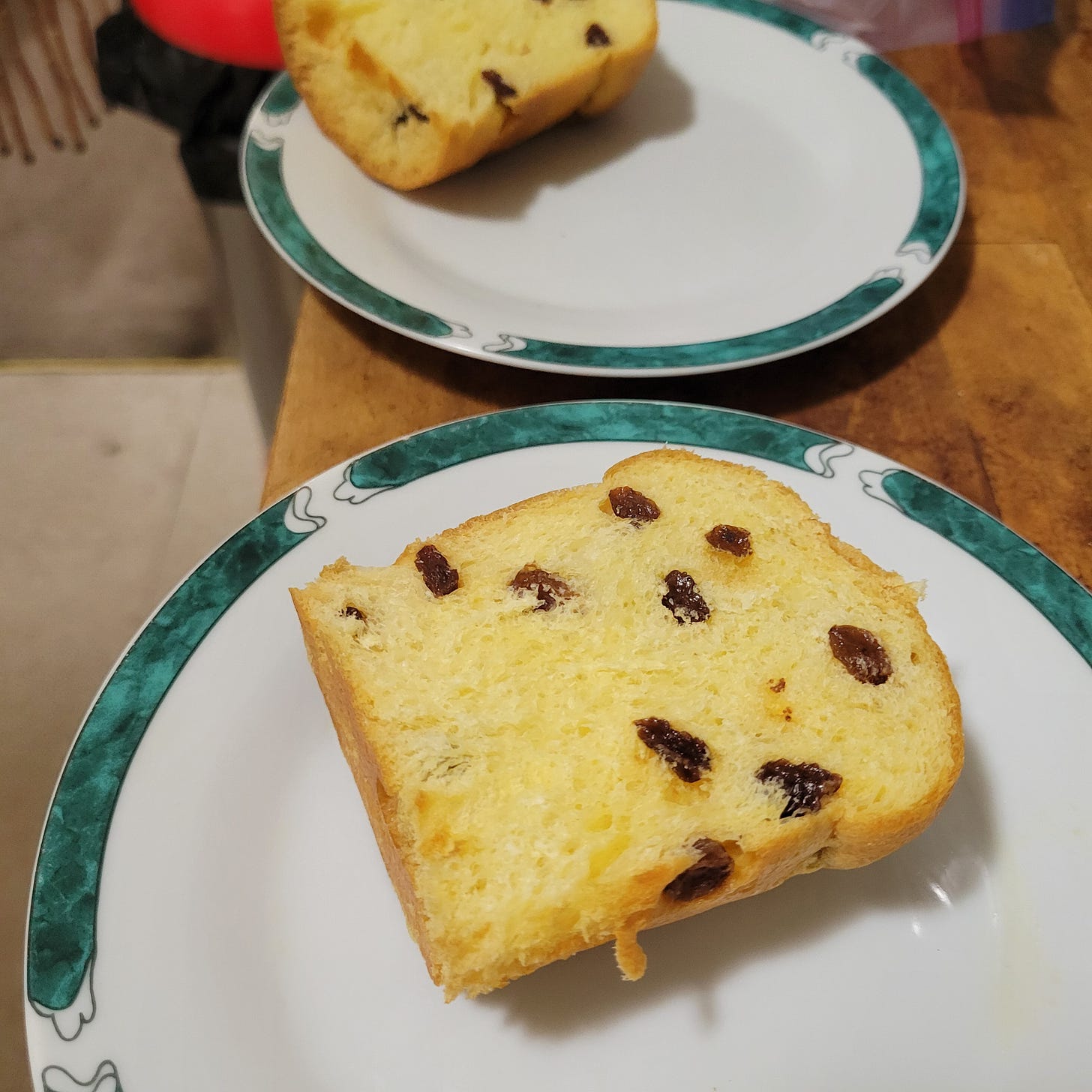 two plates with a slice of panettone each