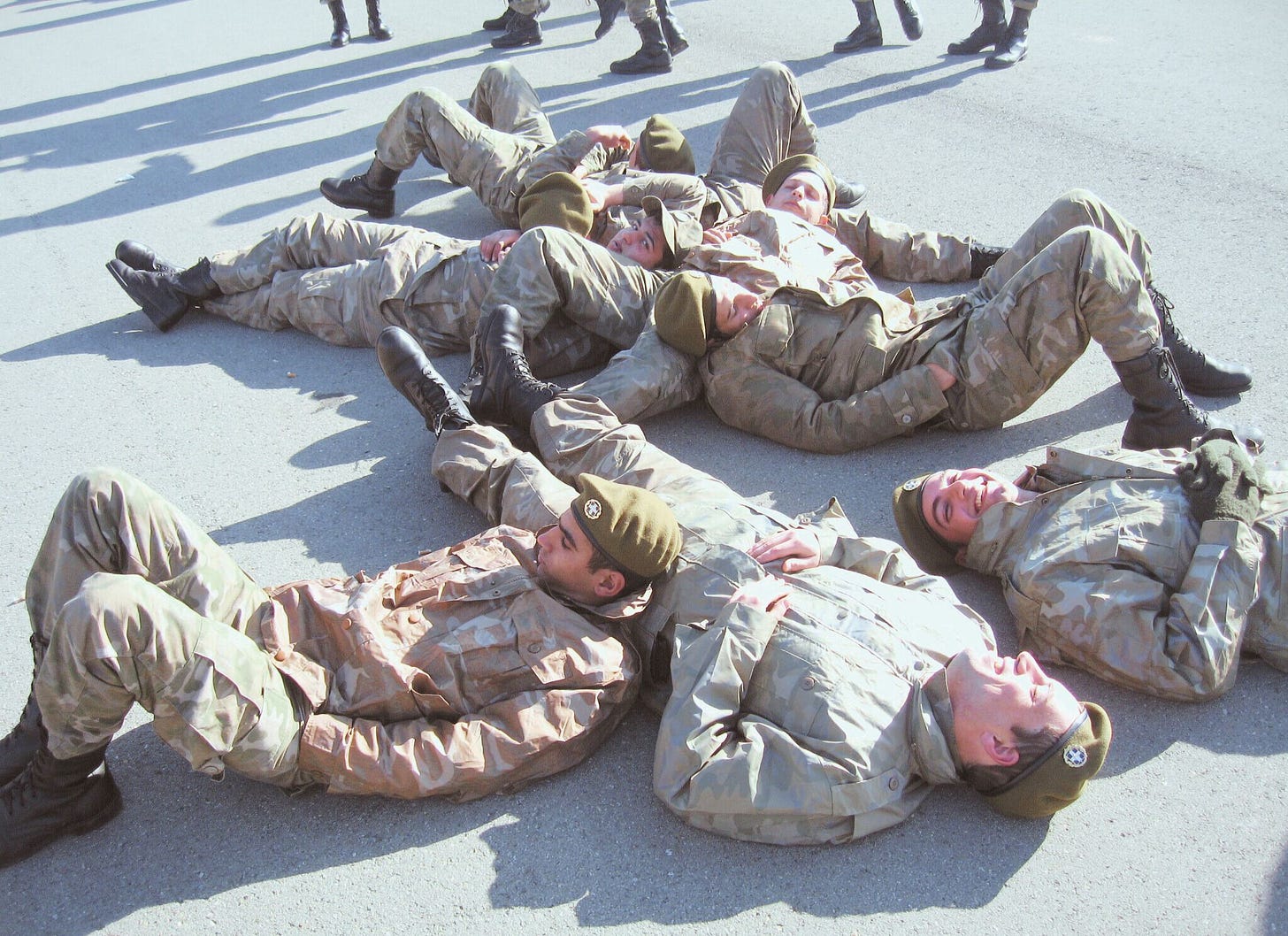 army conscripts lounging on their backs in the sun