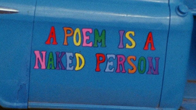 documentary title painted in colorful letters on the side of an old truck's door