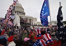 A crowd of protestors moving towards the Capitol building.