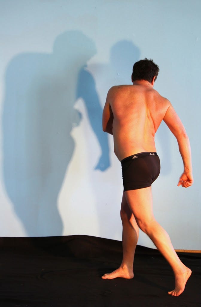 Man in boxer-briefs posing