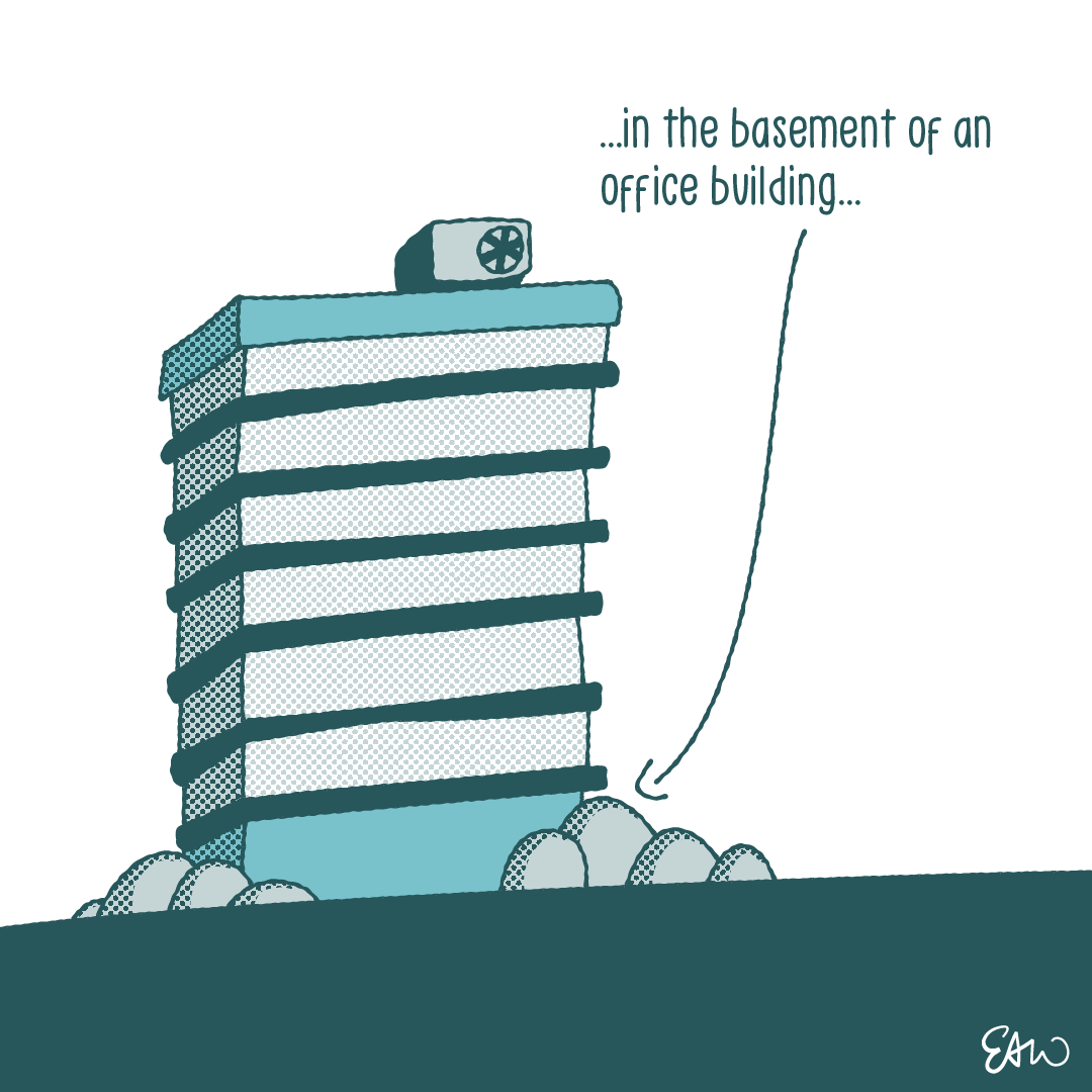 Panel six of ten. The caption starts and ends with an ellipsis, and reads, “in the basement of an office building.” The illustration shows the exterior view of a modern sky scraper. A pointed draws a connection between the caption and the basement level of the building.