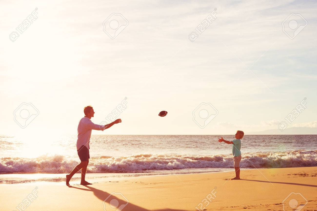 Father And Son Playing Catch Throwing Football On The Beach At Sunset Stock  Photo, Picture and Royalty Free Image. Image 48345333.