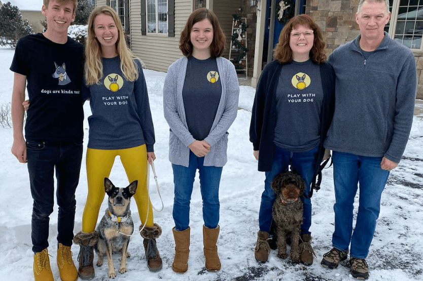 Scout the Australian cattle dog posing with her owner's family