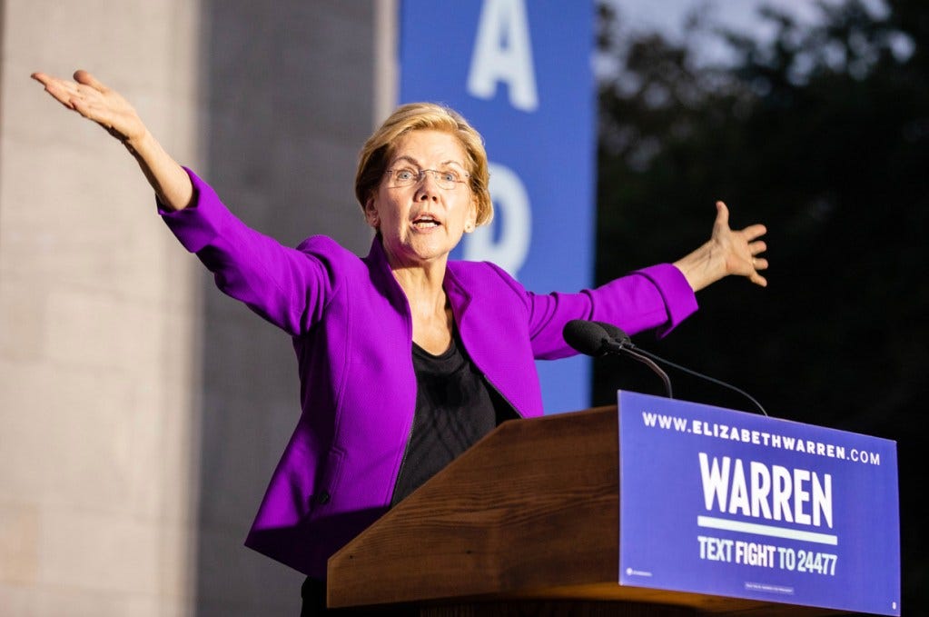 Elizabeth warren with her hands outstretched 