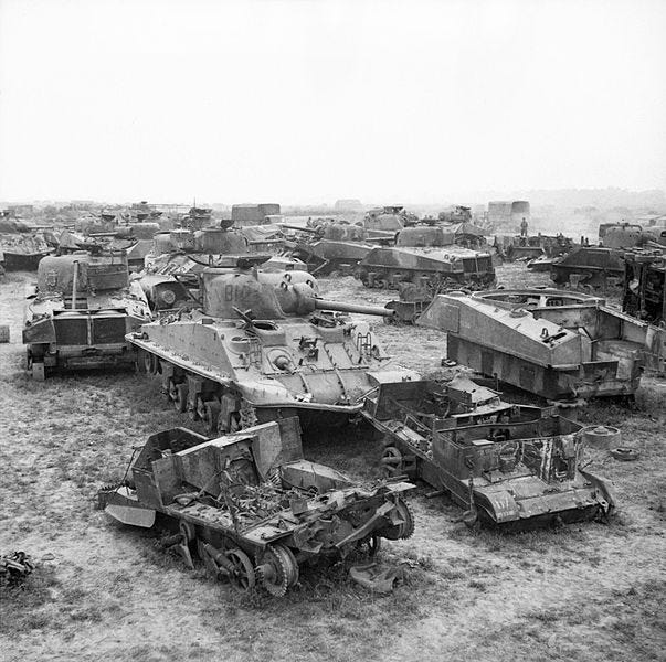 File:The remains of Sherman tanks and carriers waiting to be broken up at a British vehicle dump in Normandy, 1 August 1944. B8394.jpg