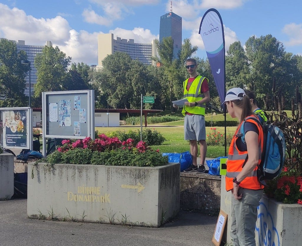 Skyscrapers look over the park, while a hi-viz wearing volunteer gives the German-language briefing. An English one followed.