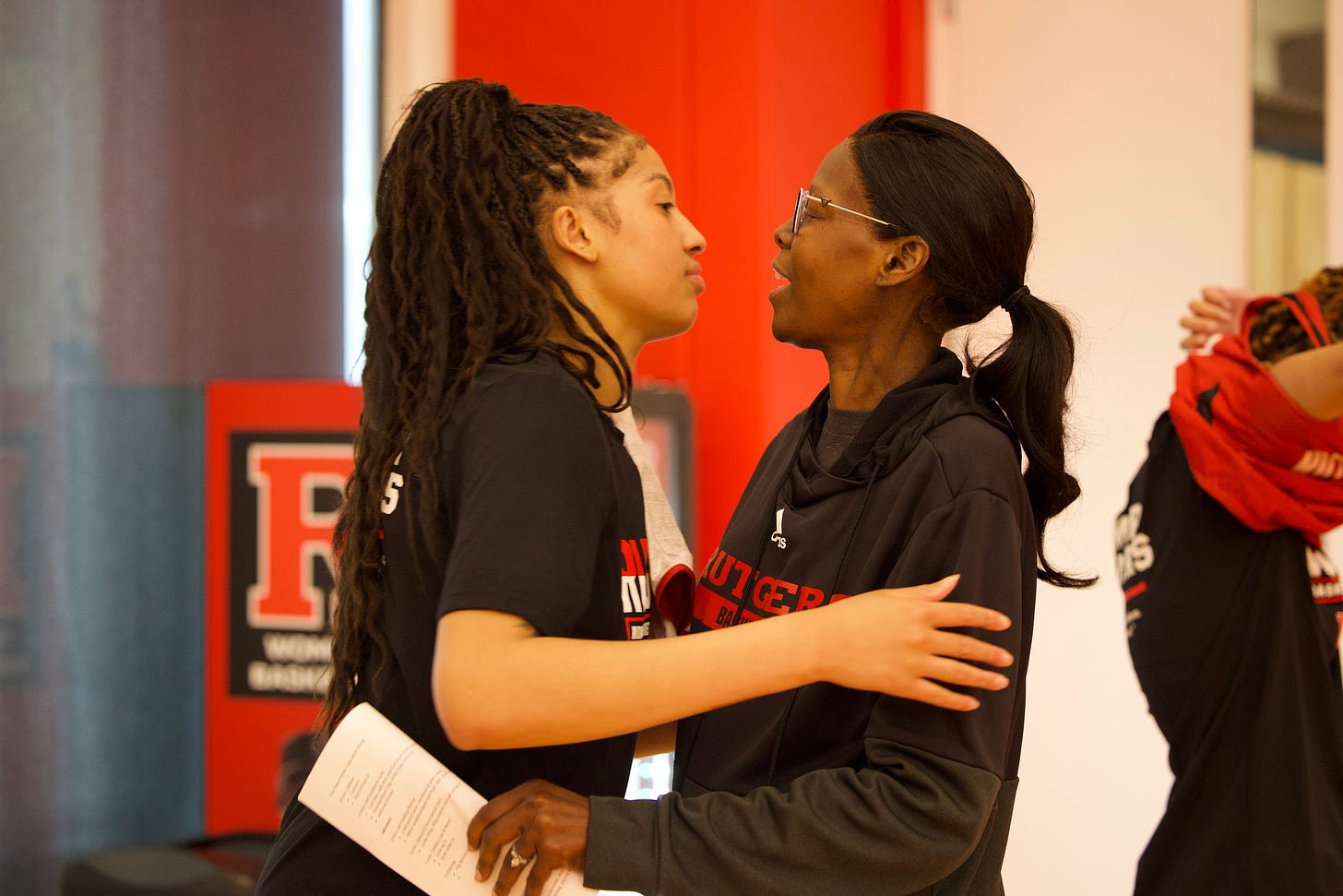 Late Rutgers assistant coach Coquese Washington (right) speaks with Kaylene Smikle at a practice. (Photo courtesy of Rutgers athletics)