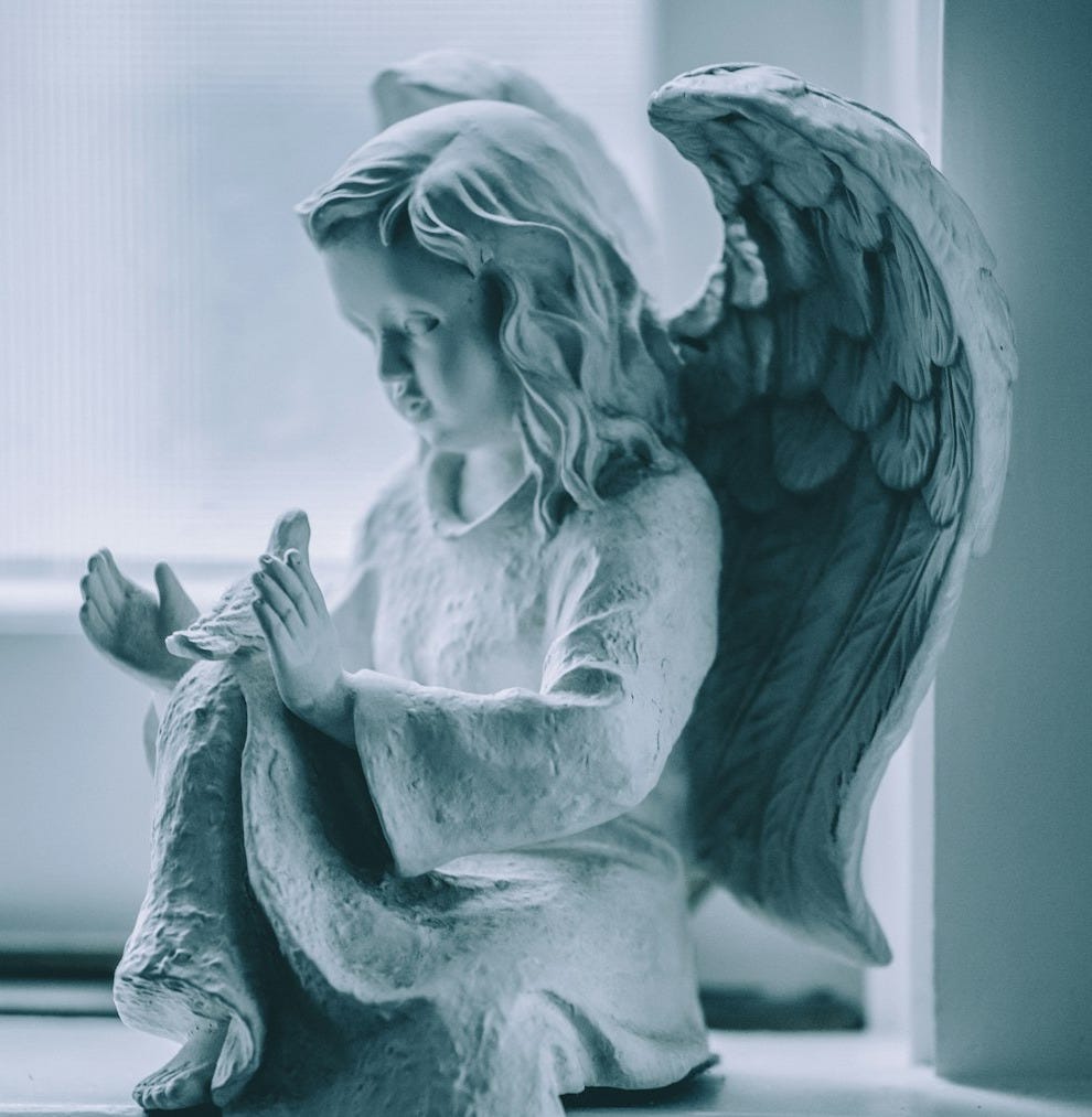 angel ceramic figurine on black table angel ceramic figurine on black table