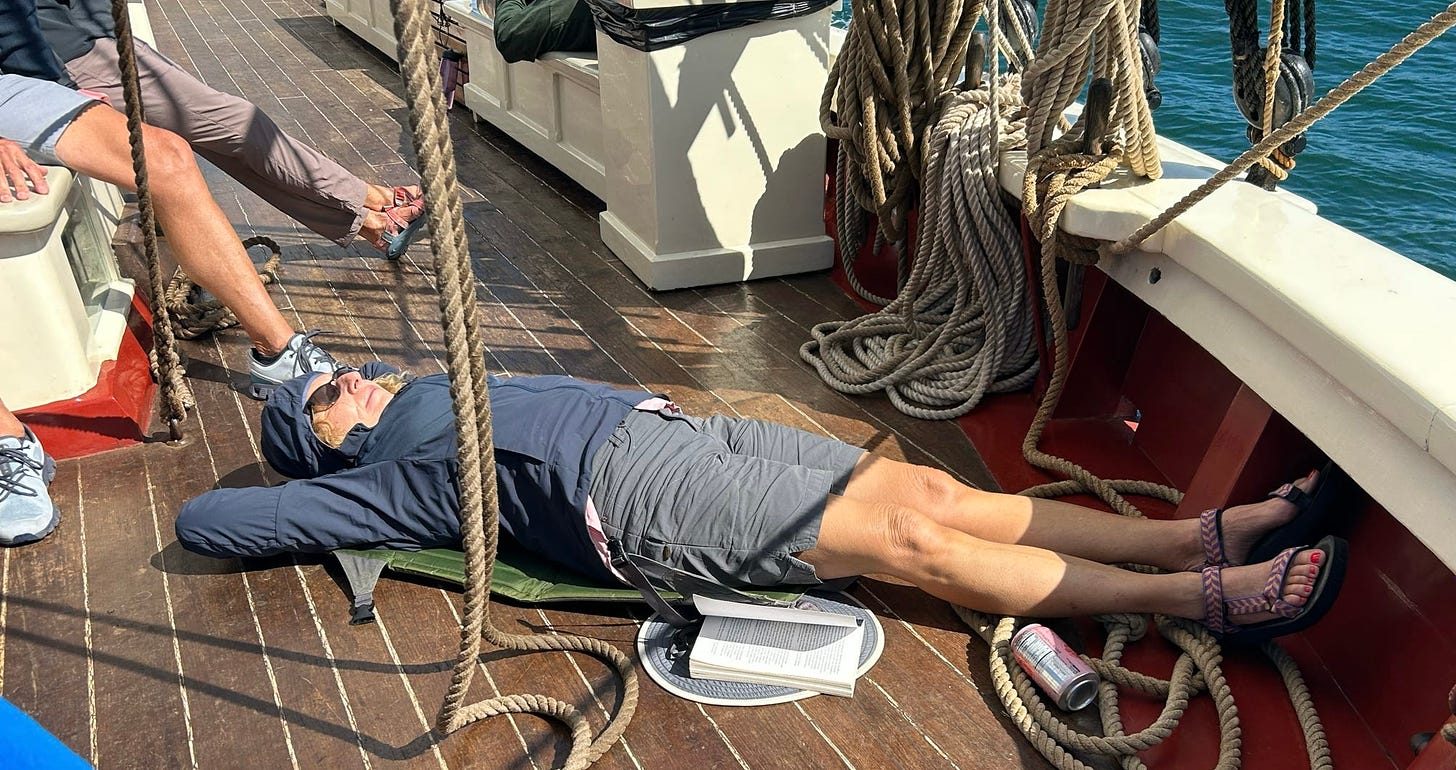 Woman lying on sailboat deck